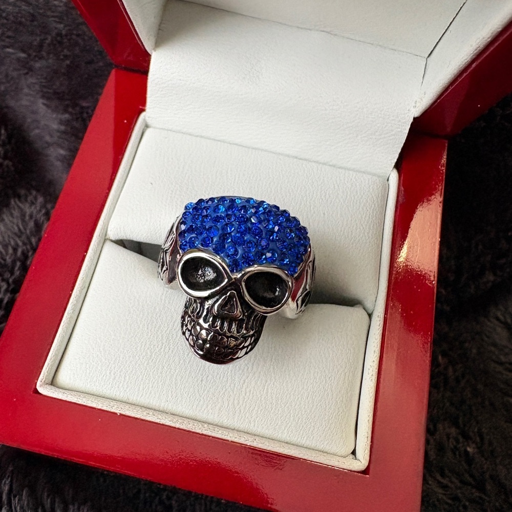 Stainless Steel Skull Ring with Blue Crystal Top. 
Beautiful Vivid Blue Sparkle.